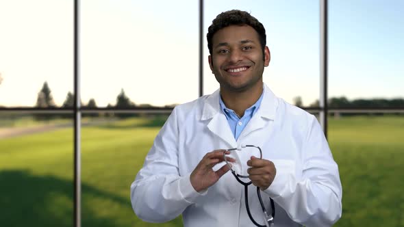 Young Handsome Doctor Puts on Stethoscope.