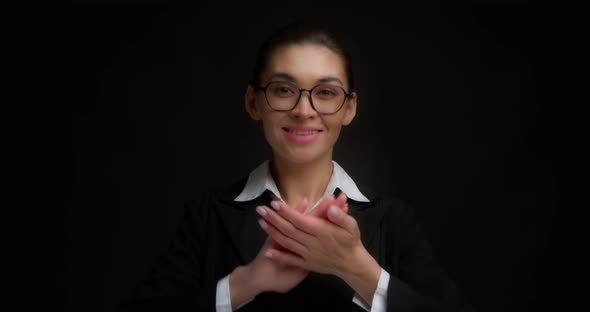 Business Woman Claps Her Hands Applauds Standing on a Black Background