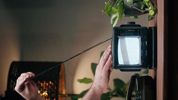 Vertical Video of Turning Off Small Old Television with Grey Interference Screen on Home Background