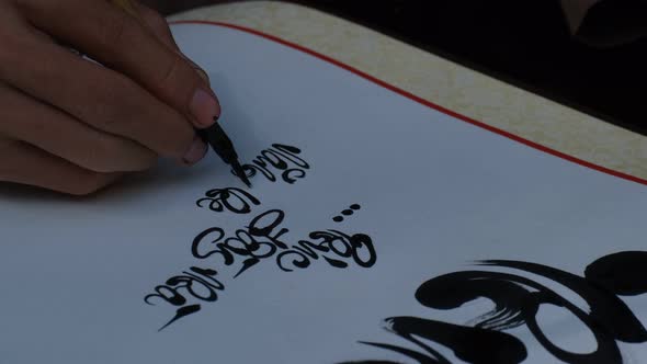 Vietnamese scholar writing calligraphy at lunar new year