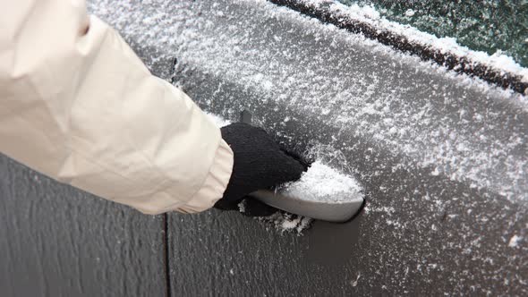 Hand In Black Glove Trying To Open Frozen Car Door Handle During Winter