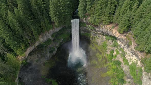 Helicopter Slow Motion View Of Tall Waterfall At Massive Crater In British Columbia Canada