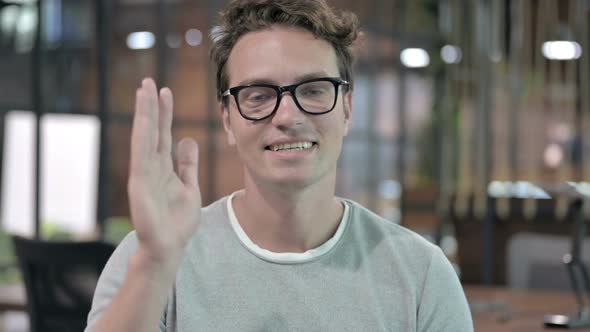 Portrait Shoot of Cheerful Guy Waving and Talking