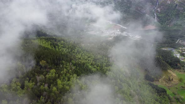 Beautiful high altitude view through passing clouds of Kinsarvik hardanger - Rotating aerial passing