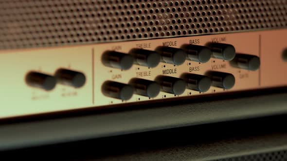 Close-up Of Amplifier Head Controller. Volume, treble, middle, Gain, Bass knobs