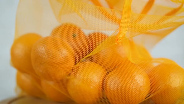 String Bag with Oranges in Hands