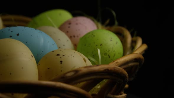 Rotating shot of Easter decorations and candy in colorful Easter grass