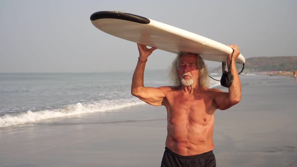 Healthy Active Old Male Surfer at the Sea