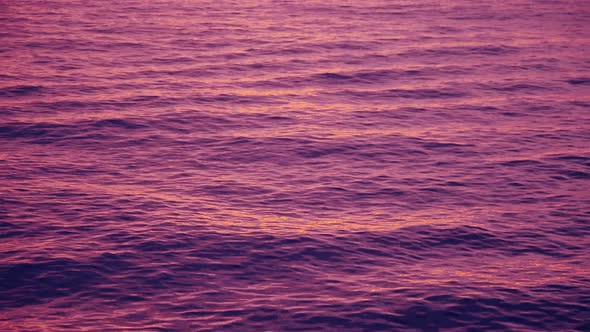 Pink Afterglow on Waves after a Sea Sunset 4k