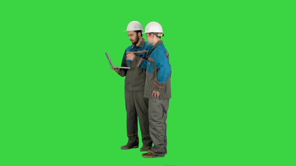 Supervisors Using Laptop at Construction Site on a Green Screen, Chroma Key
