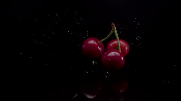 Cherry Slow Motion Closeup Falling in Water with Splash Droplets