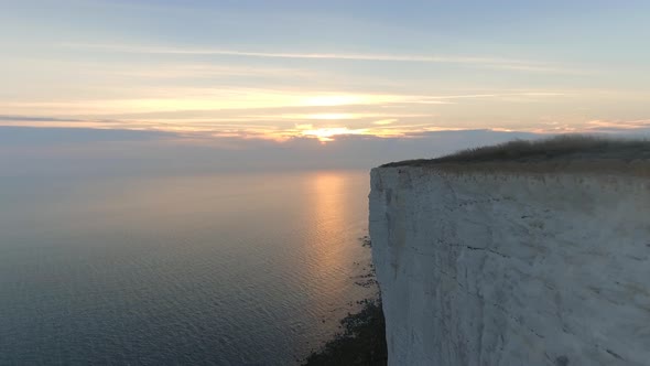 Low and Fast Flight Over a Steep Cliff Edge Towards the Setting Sun