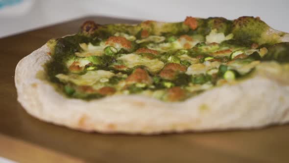 Slow Motion Pan from left to right of a delicious homemade Italian pizza with a sourdough crust read