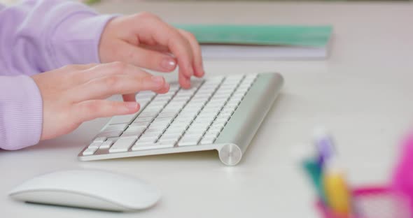 Close Up of Teen Girl Hands Typing on Keyboard and Using Mouse