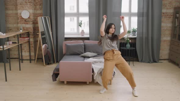 Energetic Young Woman Dancing at Home