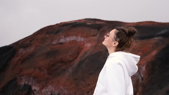 Happy Young Woman Tourist Stands Near the Crater of Tolbachik Volcano Kamchatka Landmark Close Up