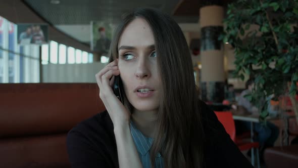 woman nervous talking on the phone