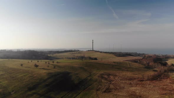 Aerial view of beautiful green hills , moving toward the sunset in Sejerøbugten, Denmark