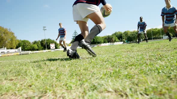 Rugby players practicing to defend the ball 