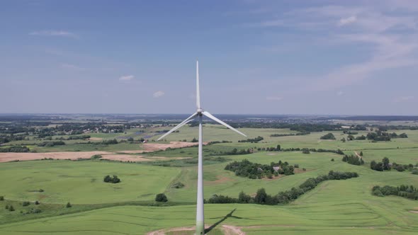 Aerial view of windmills farm for energy production on beautiful cloudy sky at highland. Wind power 