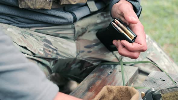 Soldier Loads Ammunition Into the Pistol Holder