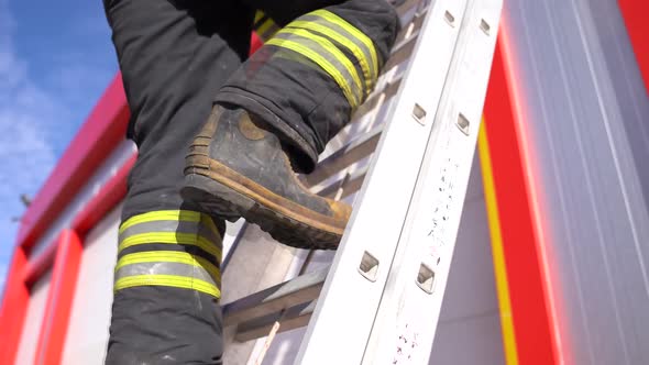 A firefighter climbs the ladder,stairs.. Fire house background. Fireman background.	