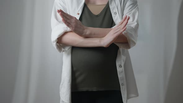 Front View Unrecognizable Pregnant Young Woman Crossing Hands Gesturing No Standing Indoors