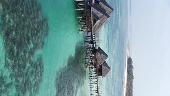 Vertical Video House on Stilts in the Ocean on the Coast of Zanzibar Tanzania Aerial View