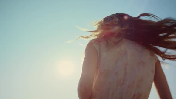 Close Up Woman with Photocamera Laughing Under Blue Sky