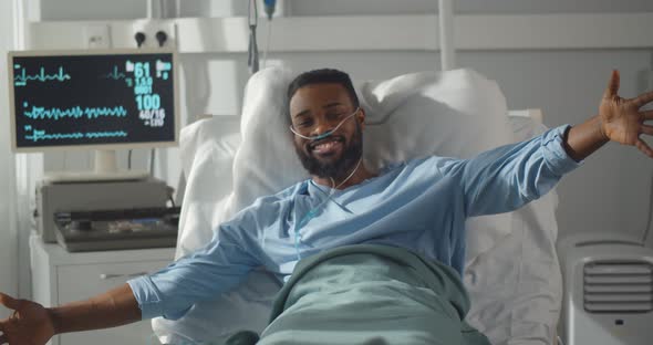 Sick African Man Lying in Hospital Bed Welcoming and Hugging Little Daughter Visiting