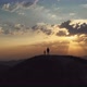An Aerial View of Man and a Boy Standing on Top of the Hill Against the Sunset - VideoHive Item for Sale