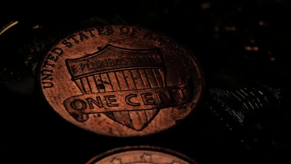 Coin Is Slightly Highlighted in a Dark Room. Close Up