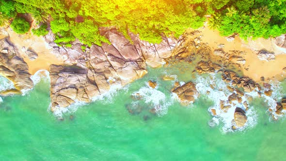 Aerial Top views over beaches, ocean waves crashing on rocks and sand