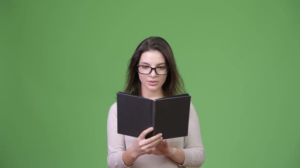Young Beautiful Woman Looking Shocked While Studying