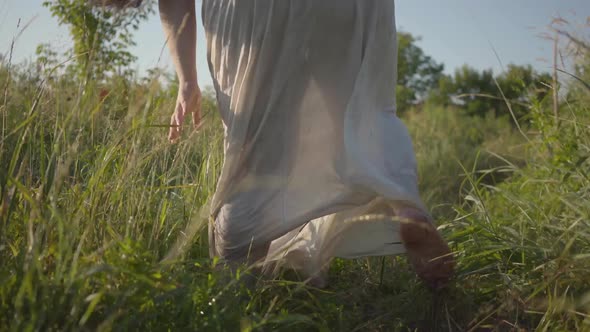 Back View of Overweight Woman in Summer Linen Dress Running on Field, Turning and Looking