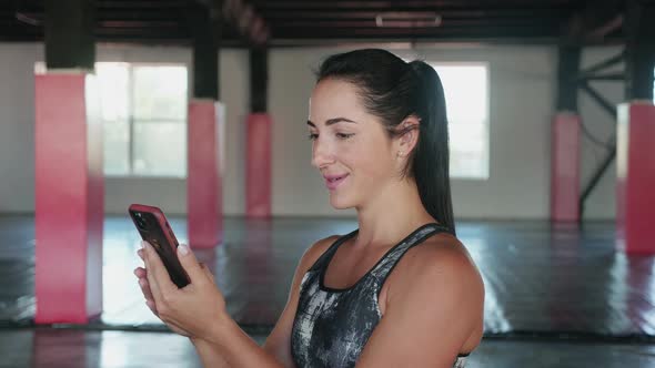 Fitness Woman Have Video Call with Smart Phone in Gym