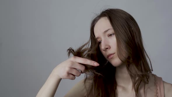 Young Woman Unhappy with Her Hair Condition