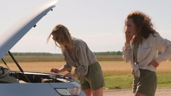 Two Women Having Trouble On Road