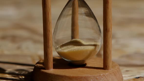 Bottom Portion of an Hourglass with Yellow Sand. Close Up