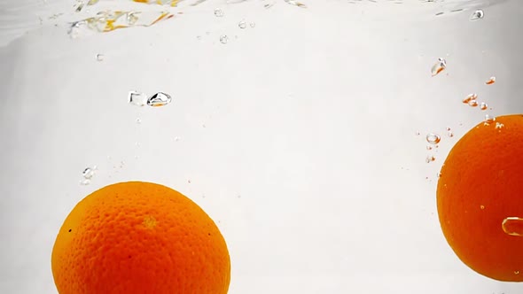 Bright Oranges Submerged the Water with Bubbles