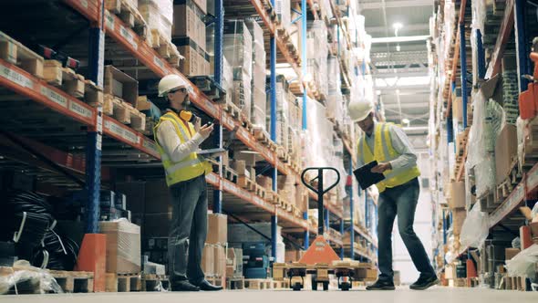 Two Warehouse Workers Fulfilling Order of Selected Items