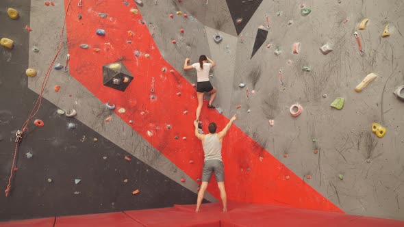 Fit Man and Woman Training at the Climbing Hall