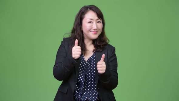 Mature Beautiful Asian Businesswoman Giving Thumbs Up