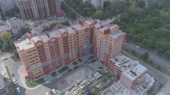 Aerial view of crane near apartment blocks