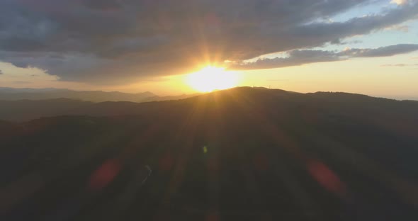 BIg Gray Clouds Above Warm Yellow Sunset in the Mountains