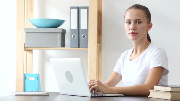 Young Woman Looking at Camera at Work in Loft Office