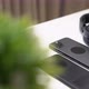 close up video of two dark smartphone and headphones on a white table - VideoHive Item for Sale