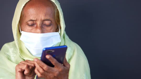 Senior Women in Face Mask Using Smart Phone