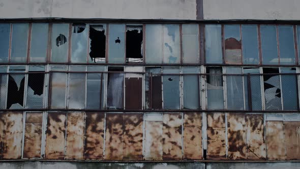 Broken Windows on the Facade of an Old Factory