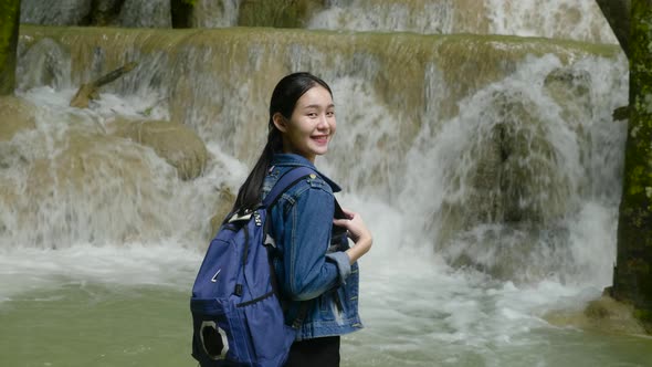 Asian Woman Hiker Smiling At Waterfall